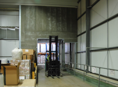 Forklift driving through warehouse