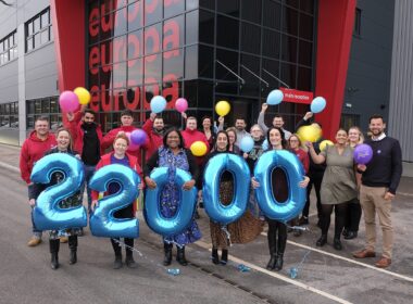 Europa Staff outside holding the number 22,000
