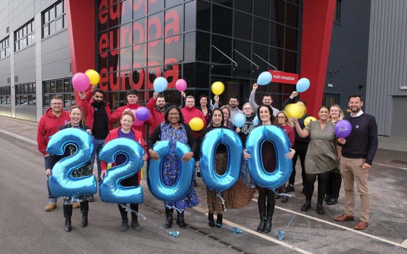 Europa Staff outside holding the number 22,000