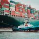 A container ship and a smaller boat next to it representing a guide to future-proofing your supply chain