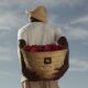Man holding basket of fruit
